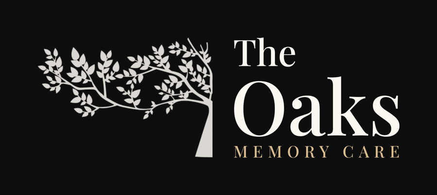 The Oaks Memory Care logo in champagne on black